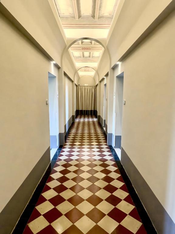 a hallway with a checkered floor in a building at San Prospero Heritage in Siena