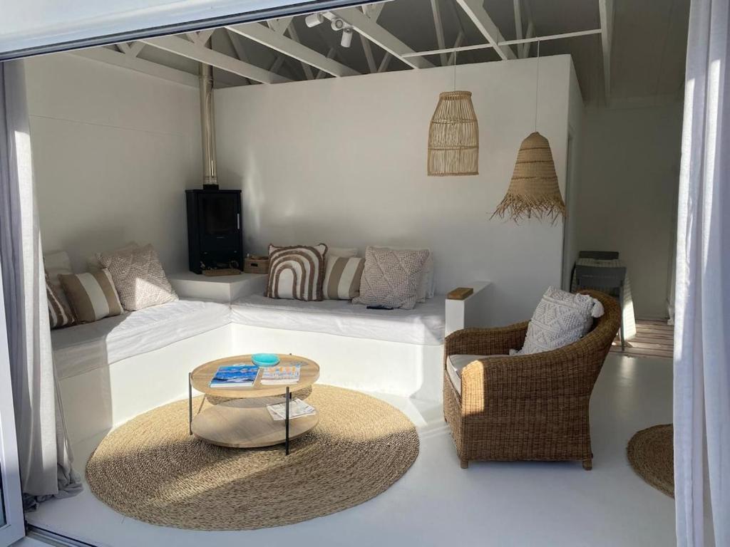 a living room with a couch and chairs and a table at Klein Griekebaan Langebaan in Langebaan