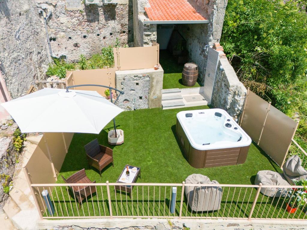 an overhead view of a garden with a hot tub and an umbrella at Casa di Zia Giovannina by Holiday World in Limina