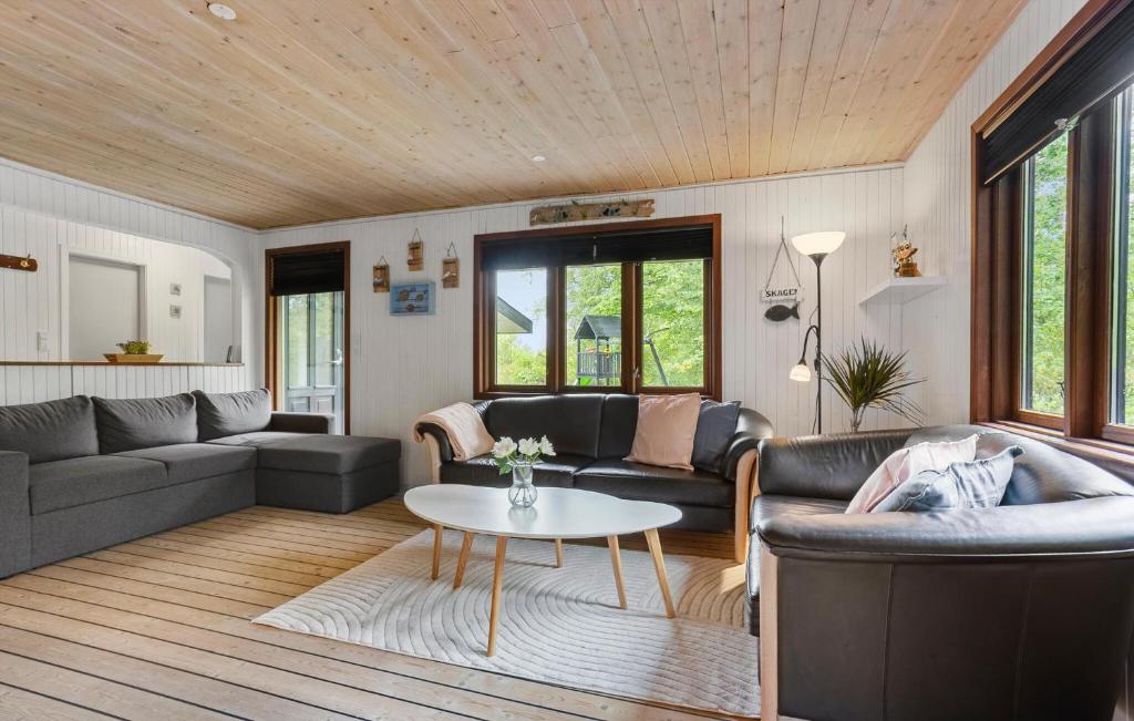 a living room with two couches and a table at 2 Bedroom Lovely Home In Skagen in Skagen