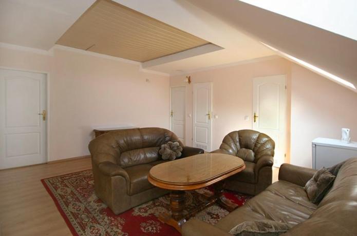 a living room with a couch and a table at Pensjonat Elżbieta in Łeba