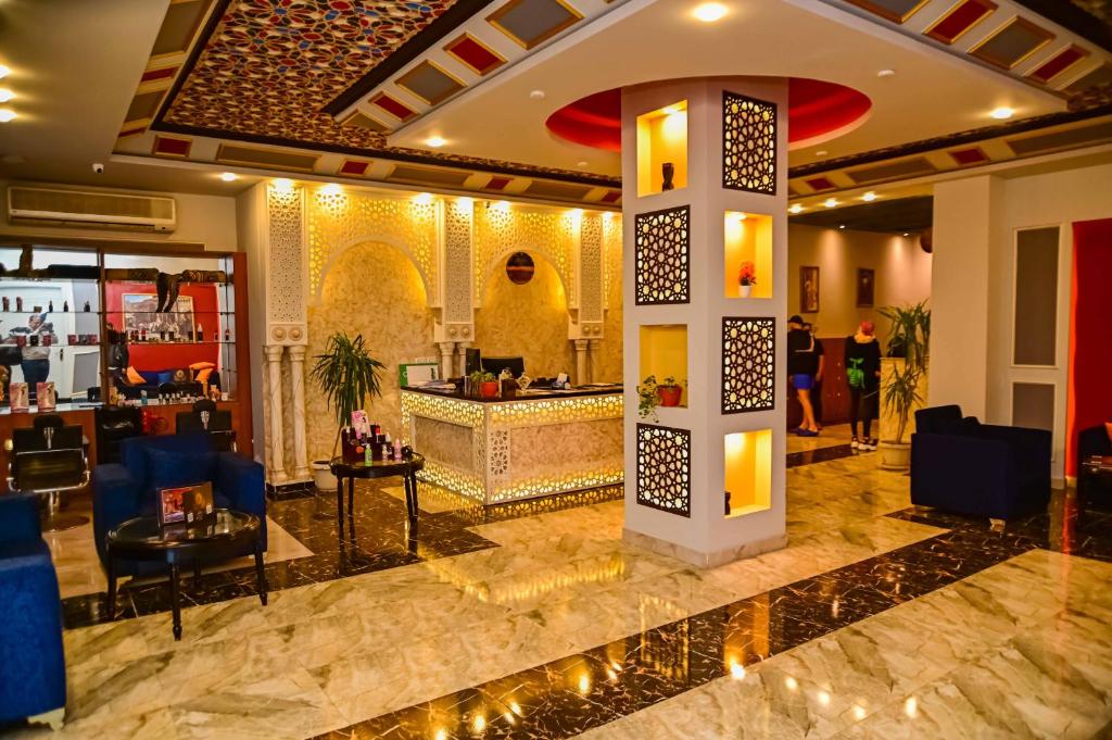 a lobby with a bar in the middle of a building at Eagles Spa in Hurghada