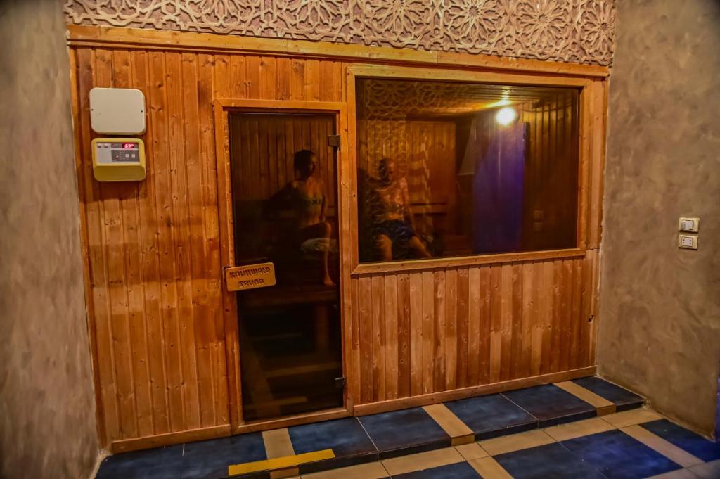 a room with a wooden wall with a window at Eagles Spa in Hurghada