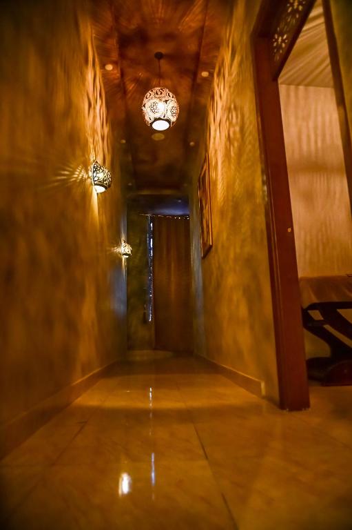an empty hallway with a chandelier in a room at Eagles Spa in Hurghada
