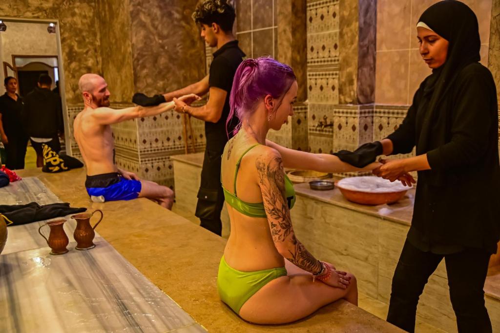 a woman in a green bikini sitting on a counter at Eagles Spa in Hurghada