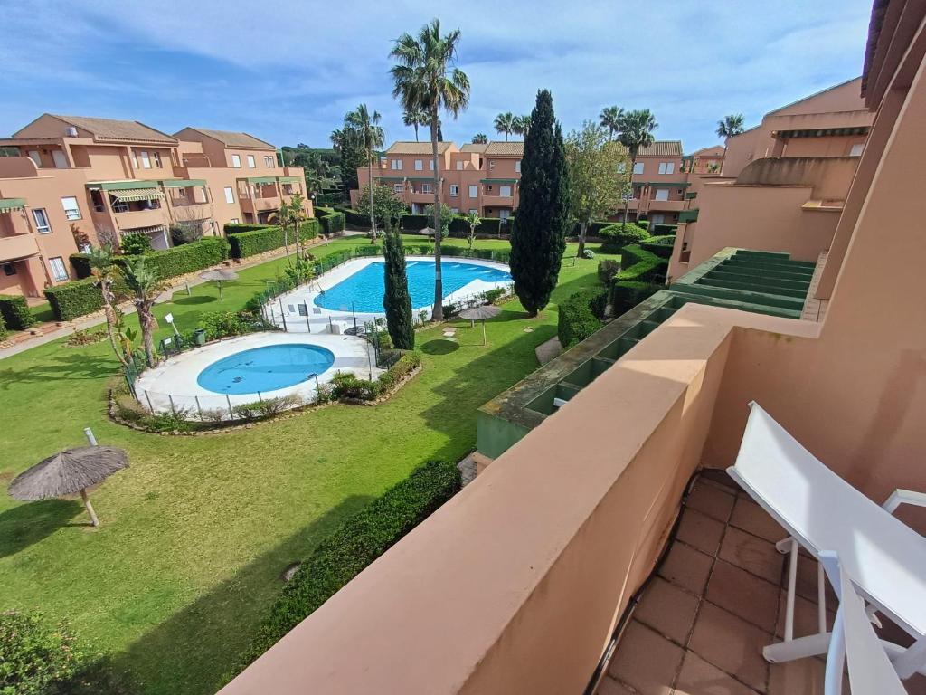 a view from the balcony of a apartment with a swimming pool at Ático "El Palomar" Rooftop in Novo Sancti Petri