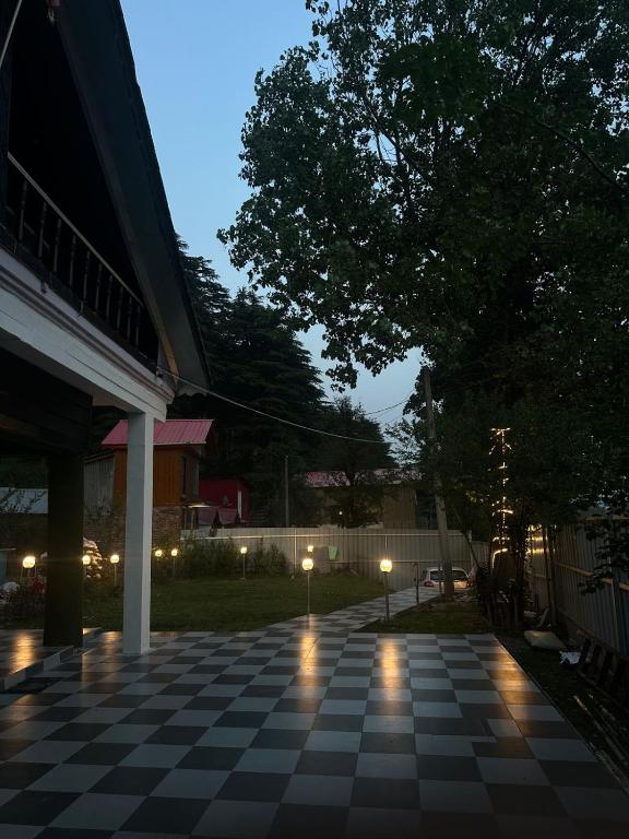 a night view of a porch with a checkered floor at Villa Royale in Kūd