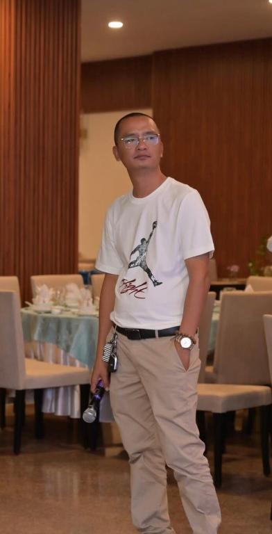 a man standing in front of a table in a room at Tiamo hose in Kon Rung (1)