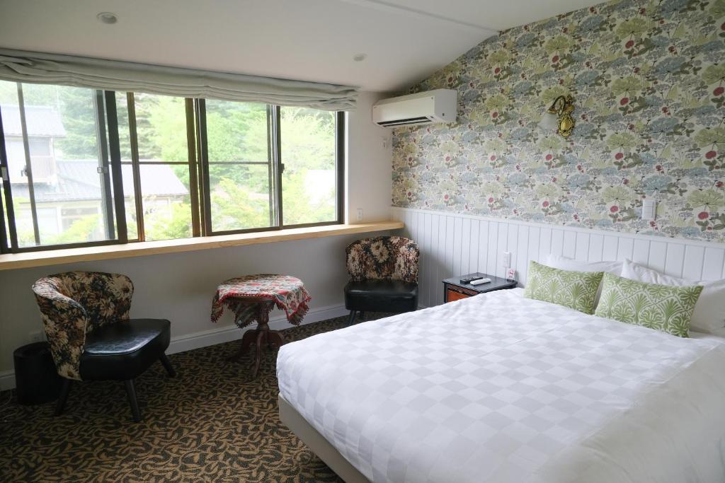Postel nebo postele na pokoji v ubytování Hotel Wellies