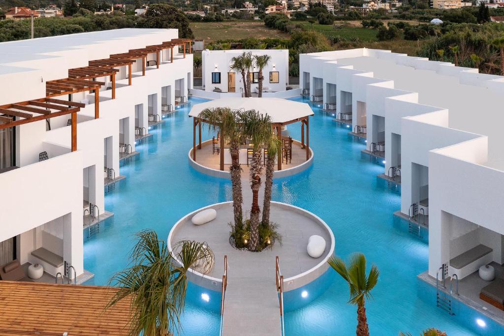 an aerial view of a hotel pool with palm trees at Martini Boutique Resort in Ialysos