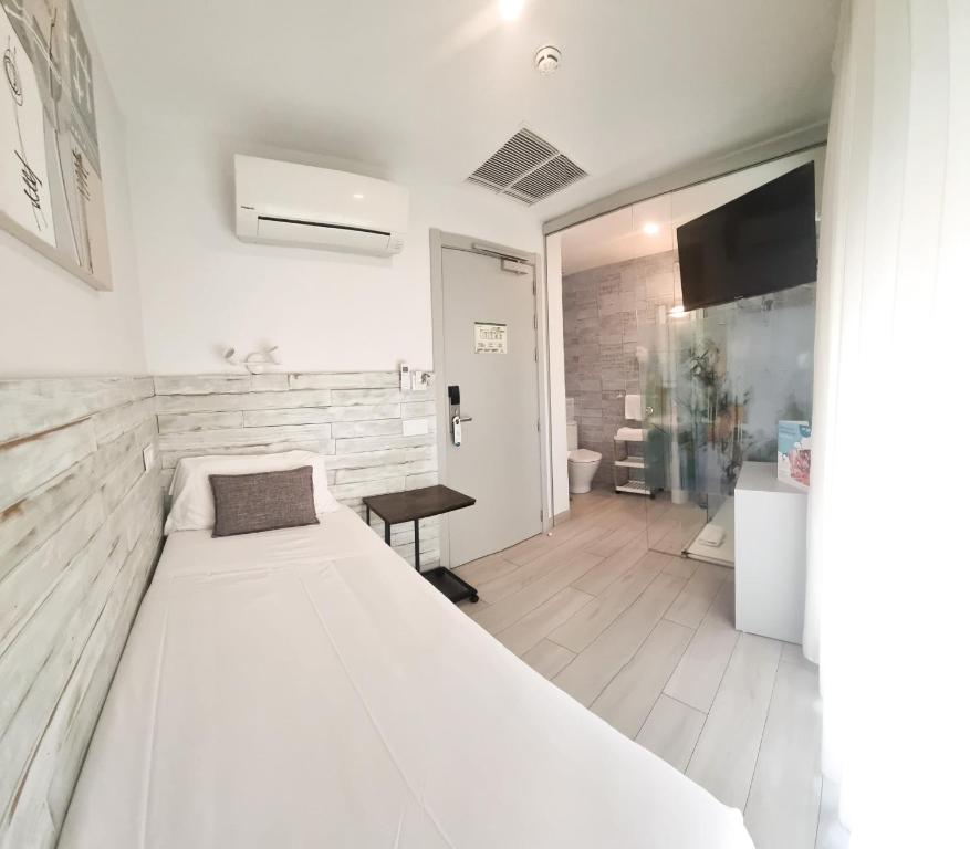 Postel nebo postele na pokoji v ubytování Hotel Clopy Rocamar