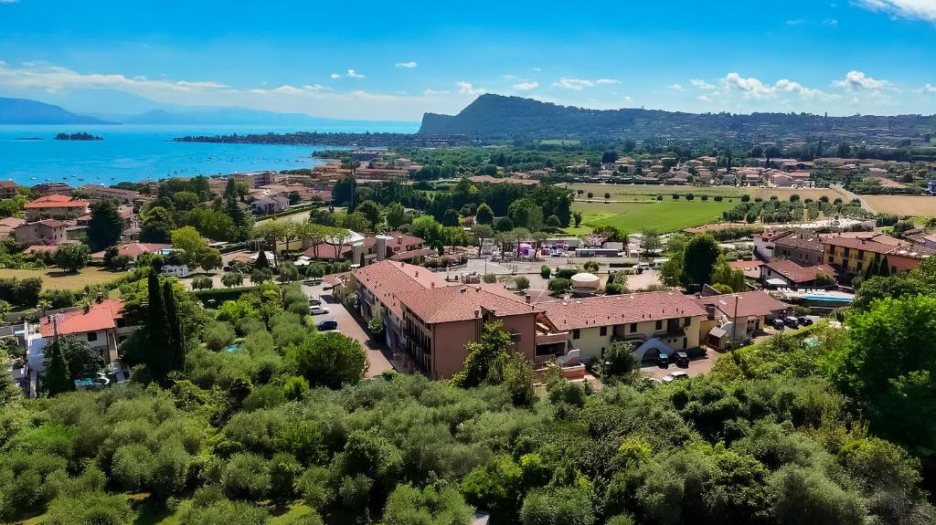 an aerial view of a small town with a lake at AHG Donna Silvia Wellness Hotel in Manerba del Garda