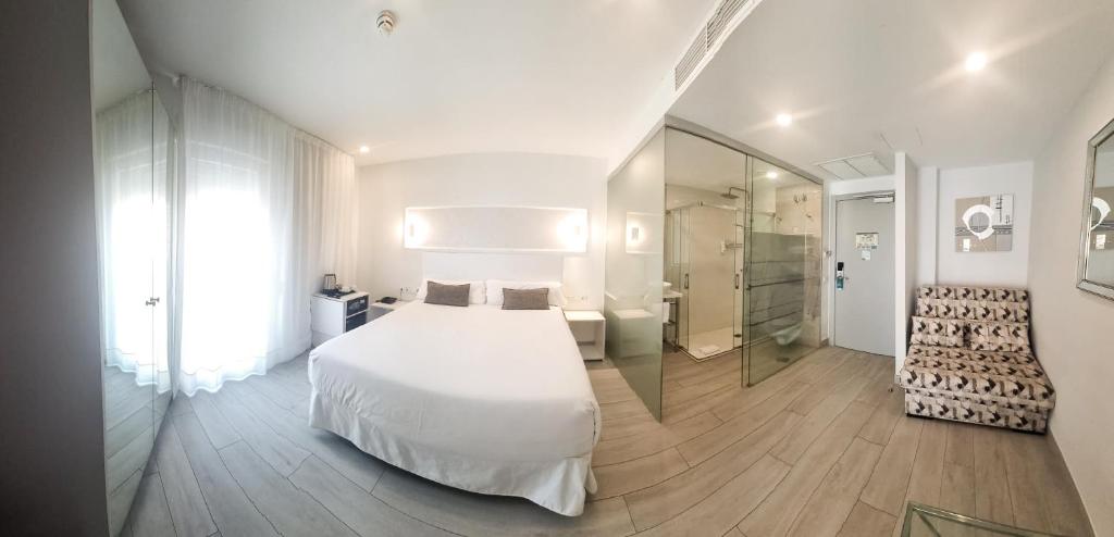 Postel nebo postele na pokoji v ubytování Hotel Clopy Rocamar