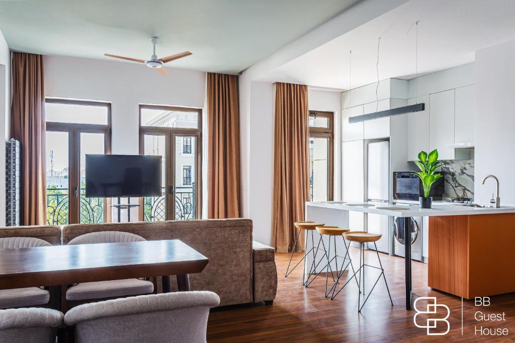 a kitchen and living room with a couch and a table at Boulevard 115 in Tashkent