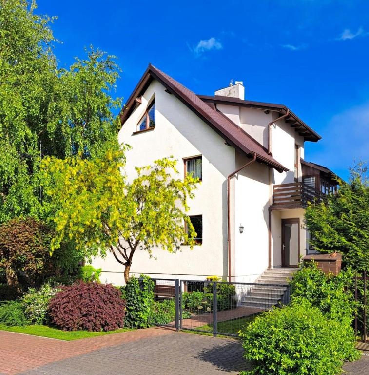 a white house with stairs in a yard at Anka in Władysławowo