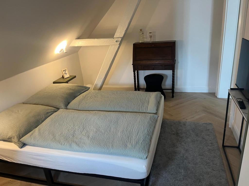 a bedroom with a bed and a piano at Ferienwohnung Rheiderland in Weener