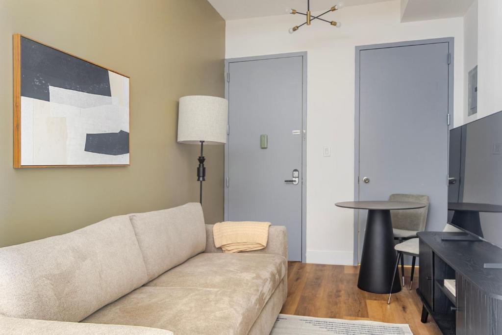 a living room with a couch and a table at Blueground Midtown West wd nr Broadway NYC-1863 in New York