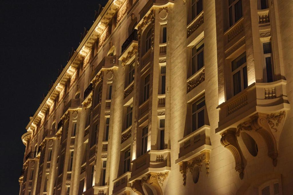a building with lights on the side of it at The Palace, a Luxury Collection Hotel, Madrid in Madrid