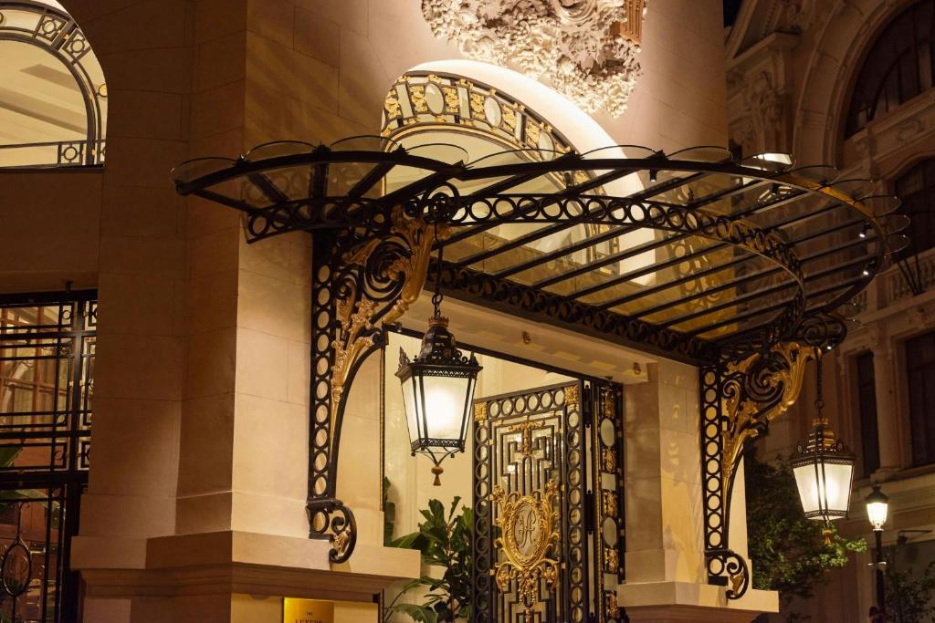 a wrought iron entrance to a building with a door at The Palace, a Luxury Collection Hotel, Madrid in Madrid