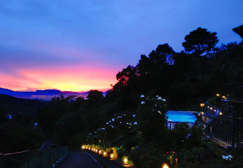 a view of a sunset from a street at night at Grand Hills kandy in Kandy