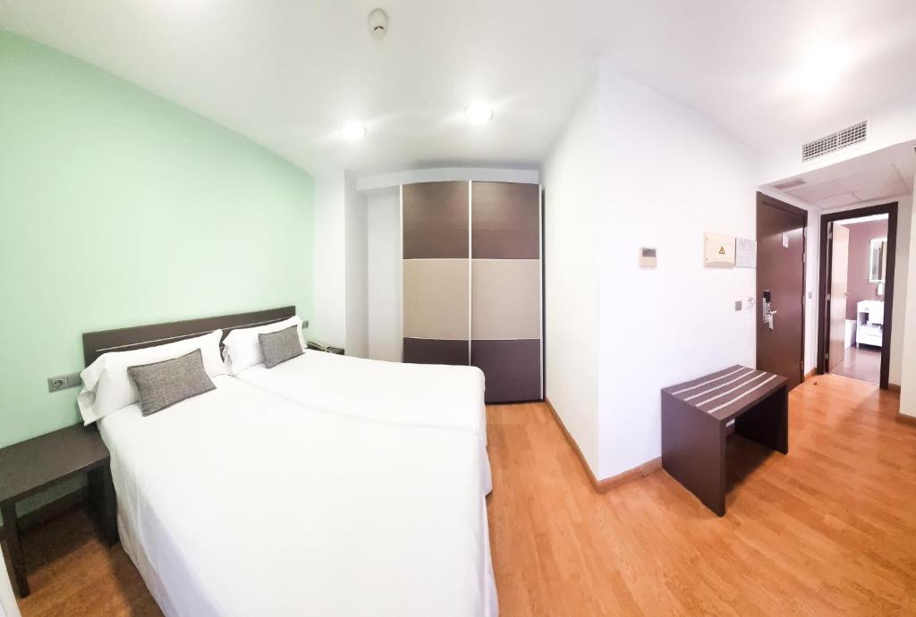 Postel nebo postele na pokoji v ubytování Hotel Clopy Rocamar