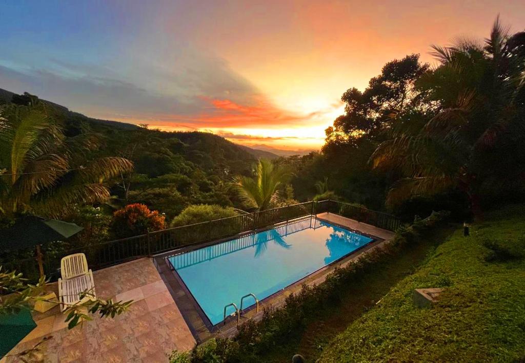 an overhead view of a swimming pool at sunset at Grand Hills kandy in Kandy