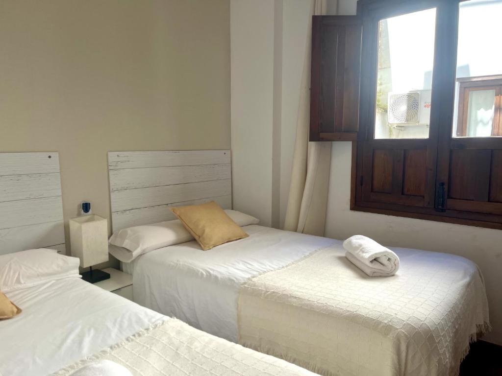 Postel nebo postele na pokoji v ubytování RIBERA SUITE CÓRDOBA