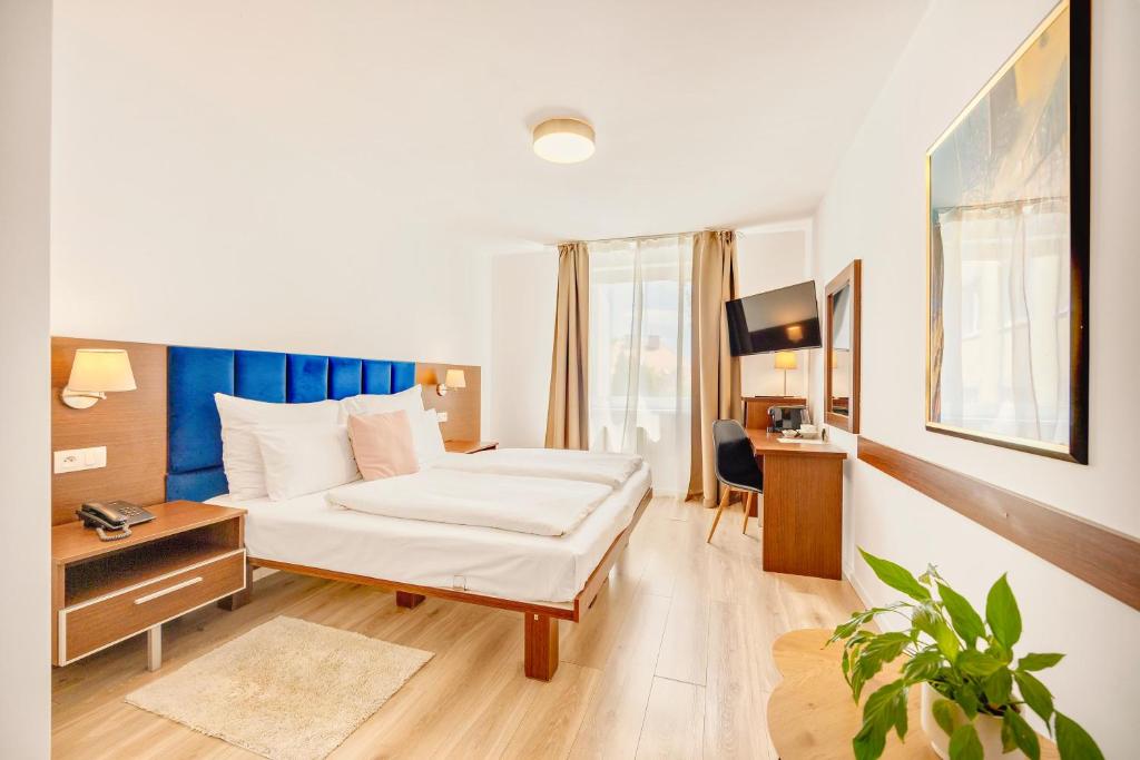 Postel nebo postele na pokoji v ubytování Hotel ANTARES