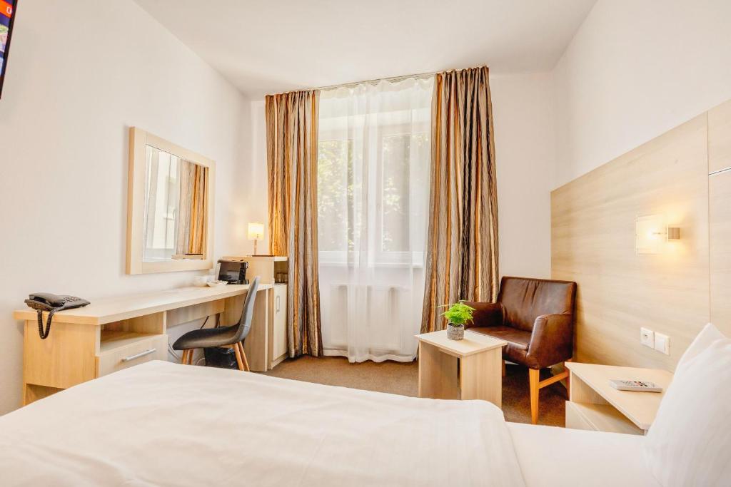 Postel nebo postele na pokoji v ubytování Hotel ANTARES