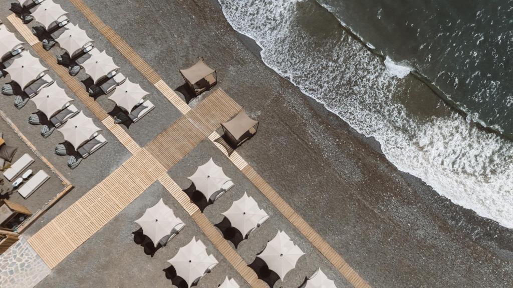 an overhead view of a beach with chairs and the ocean at Sagredo Boutique Hotel & Spa in Ágios Fokás