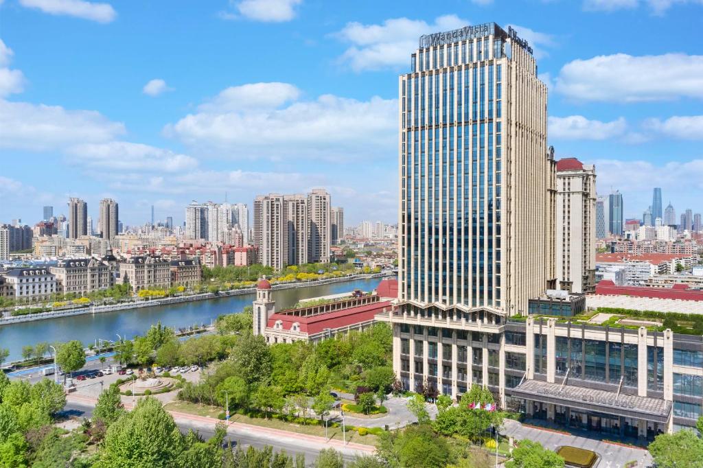 a view of a city with a river and buildings at Wanda Vista Tianjin in Tianjin