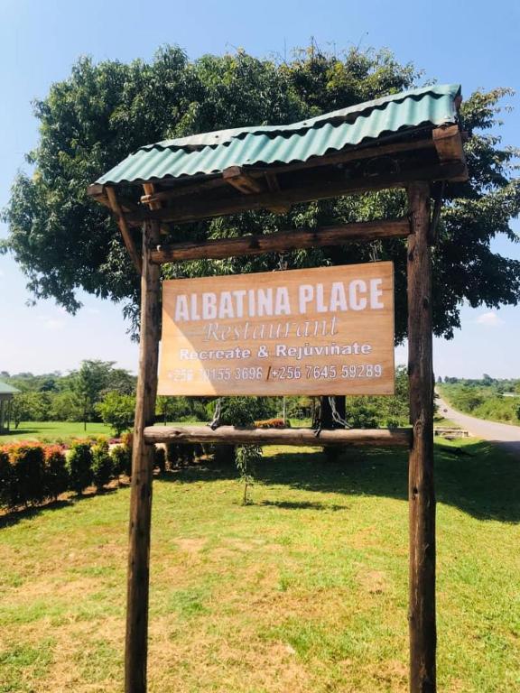 a sign for a polling place in a field at Albatina Place in Nakasongola
