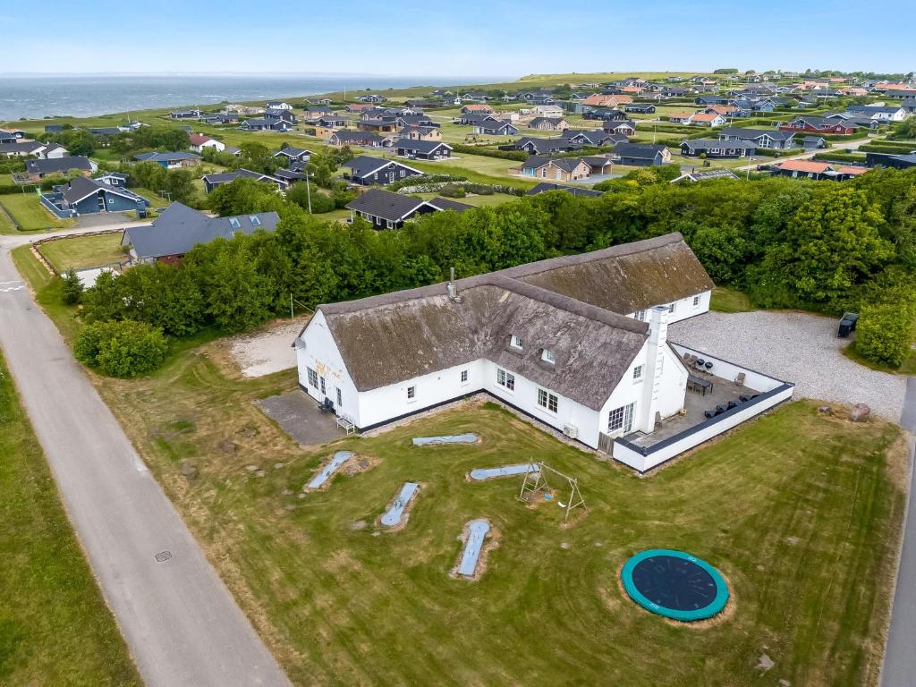 an aerial view of a white house with a frisbee at Large Pool House For 24 People, With Almost Everything In Activities, 300 Meters From The Fjord in Vinderup
