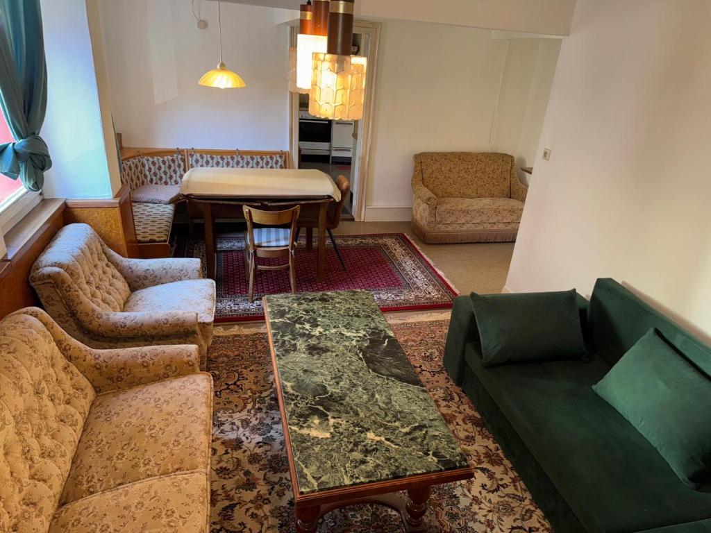 a living room with a couch and a table at Spacious Local Lounge Apartment in Kelkheim