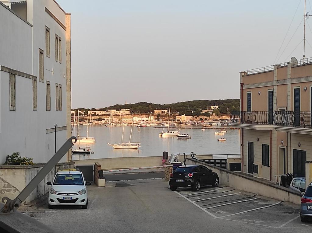 two cars parked in a parking lot next to a body of water at Dimora Zoe sea view by CASASI Vacanze Otranto in Otranto
