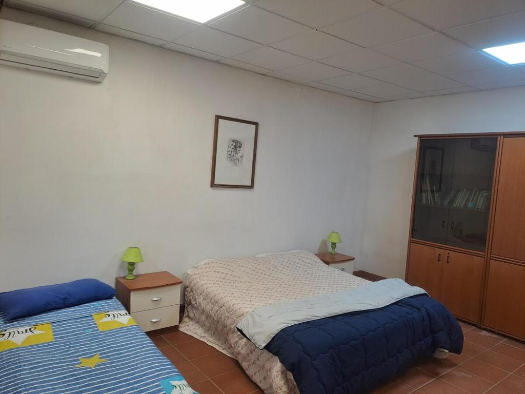 Ένα ή περισσότερα κρεβάτια σε δωμάτιο στο Ufficio al vivaio