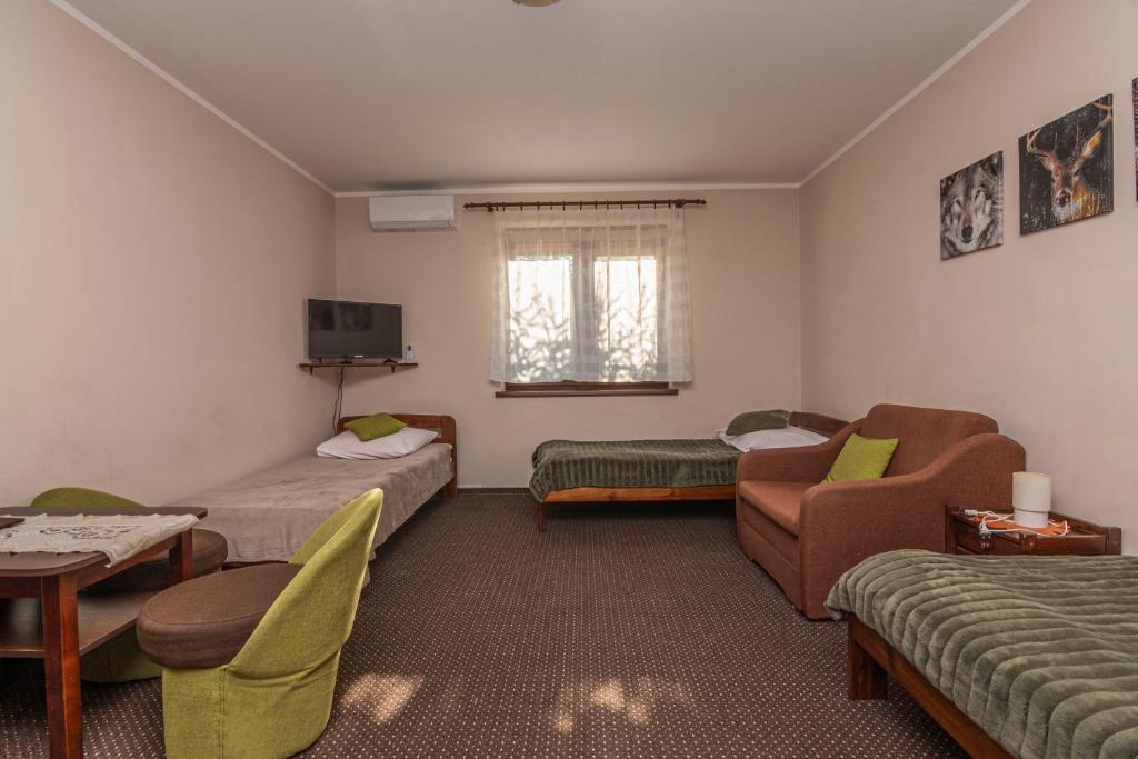 Postel nebo postele na pokoji v ubytování Dwór Na Otulinie