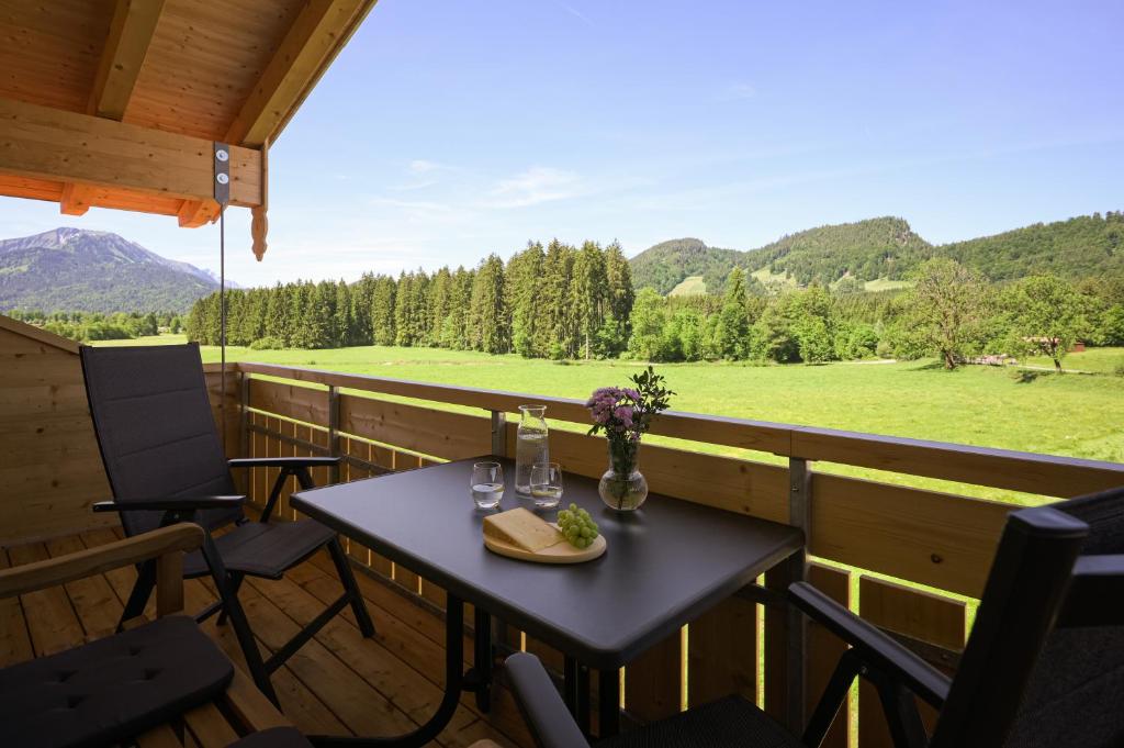 a table and chairs on a porch with a view at RUBEN 15 Ferienwohnungen in Oberstdorf