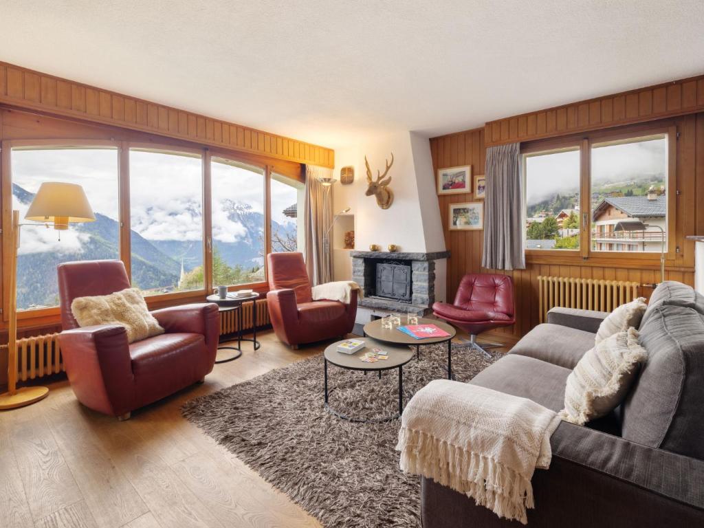 a living room with a couch and chairs and mountains at Apartment La Toura by Interhome in Verbier