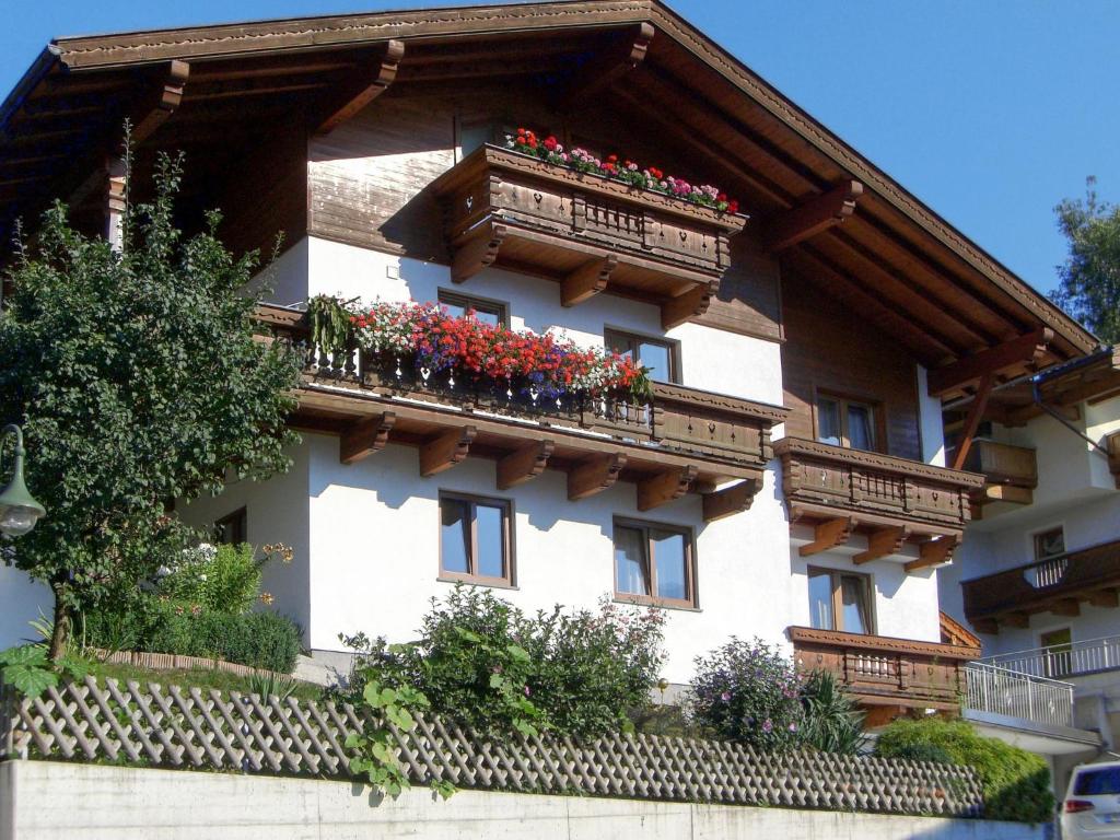 a building with balconies with red flowers on it at Apartment Neurauter-1 by Interhome in Fügen
