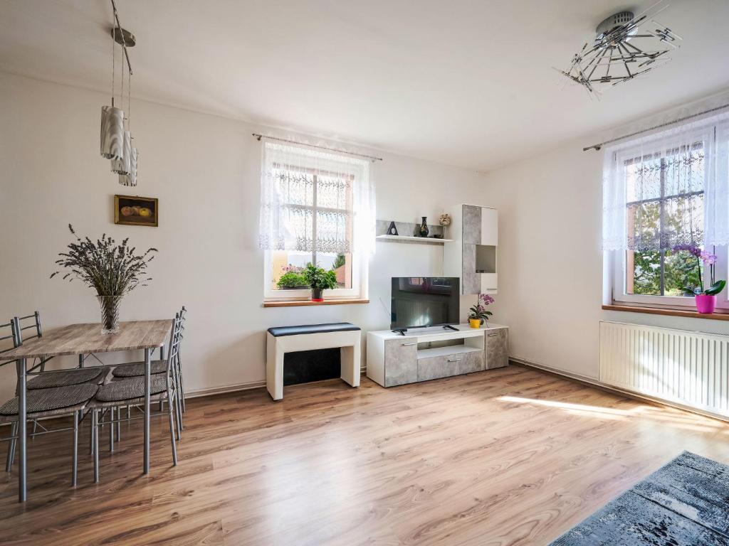 a living room with a dining table and a television at Apartment Formanka by Interhome in Liberec