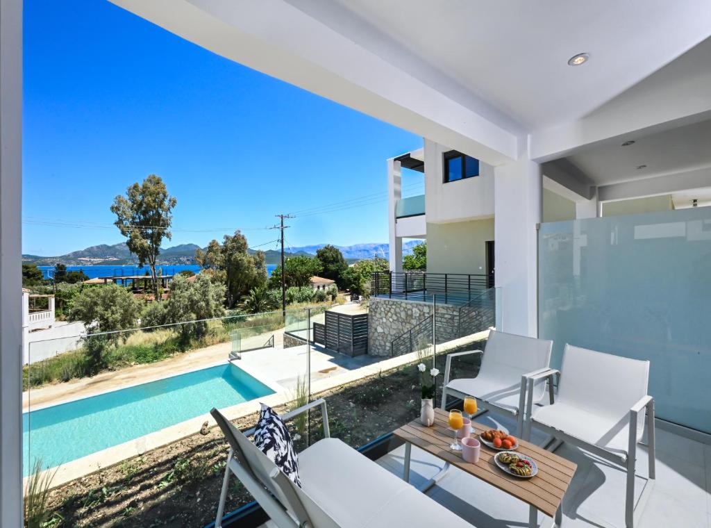 a view from the balcony of a house with a swimming pool at Ionian Pearl Studio in Nikiana