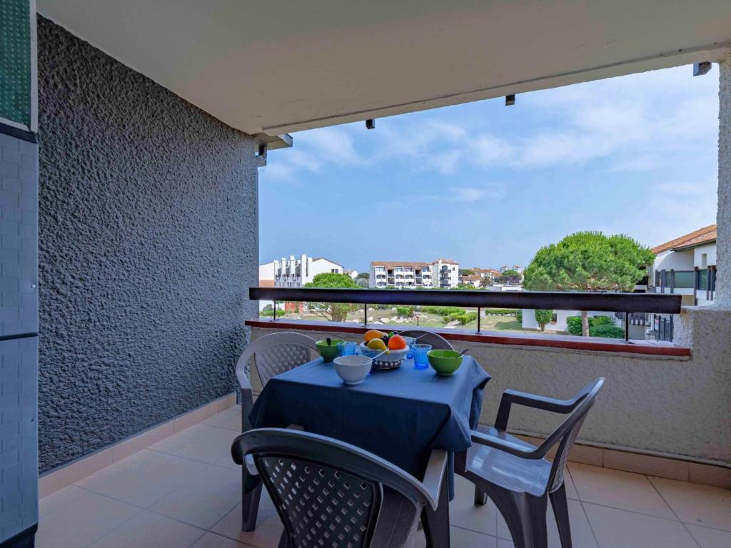 une table bleue et des chaises sur un balcon dans l'établissement Apartment Coudalère-Les Hébrides-4 by Interhome, au Barcarès