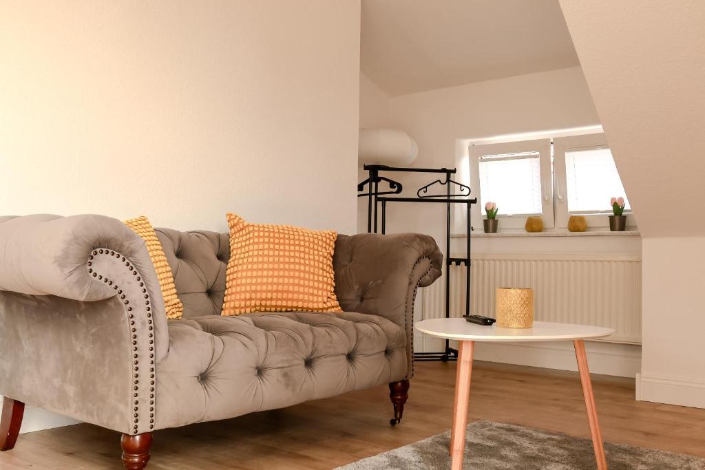 a living room with a couch and a table at Pension Kastanie in Sehlen
