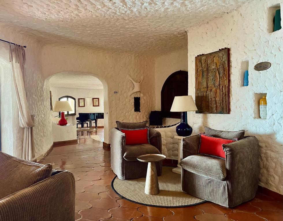 a living room with two chairs and a table at Hotel Don Diego in Porto San Paolo