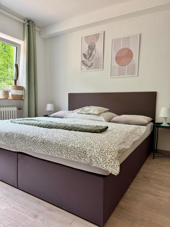 a bedroom with a large bed in a room at ausZEITlarn - Apartment in Zeitlarn