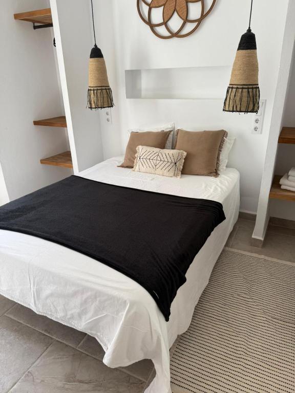 a bedroom with a bed with a black blanket at Apartamento Café Bernal in Tarifa