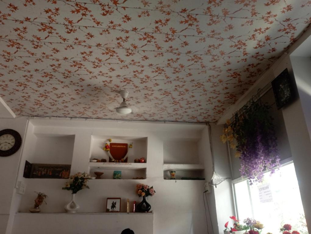 a room with a floral patterned ceiling at RL Residency in Jāmb