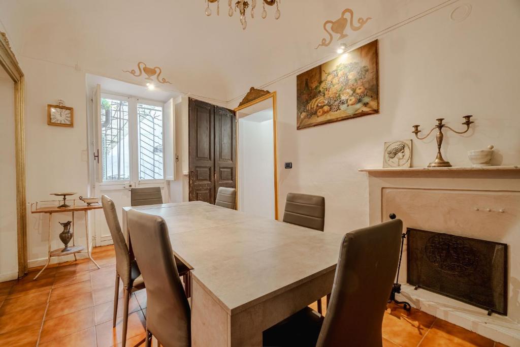 a dining room with a table and chairs and a fireplace at Piazza Vittorio Veneto Elegant Flat in Turin
