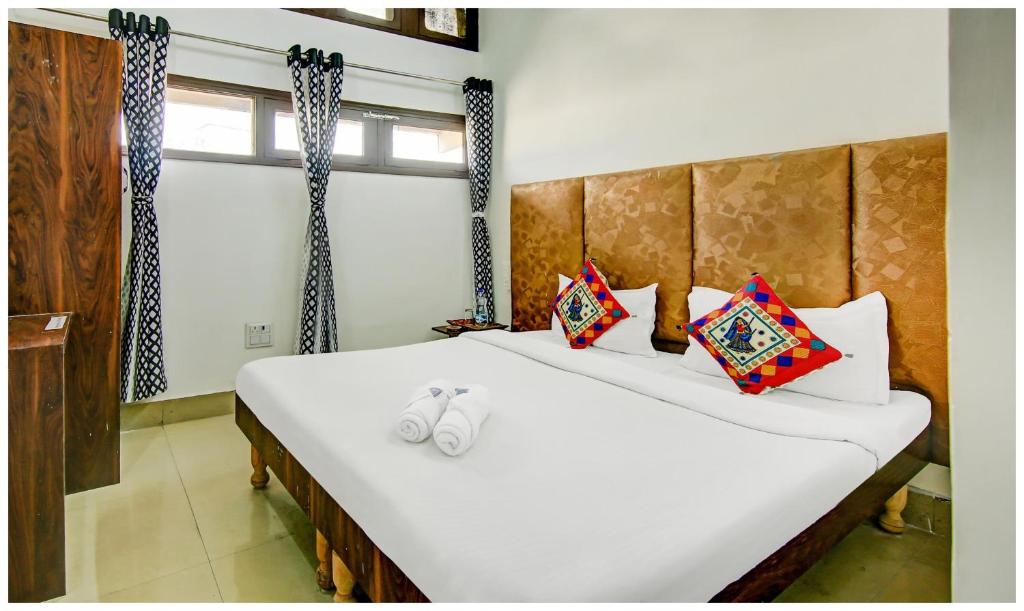 a bedroom with two beds and a window at Amritsar Hotel R-A-M-N-E-E-K Near Bus Stand - Spacious Rooms With Free Wi-fi - Restaurant# Parking & Excellent Customer Service - Best Location In Amritsar in Amritsar